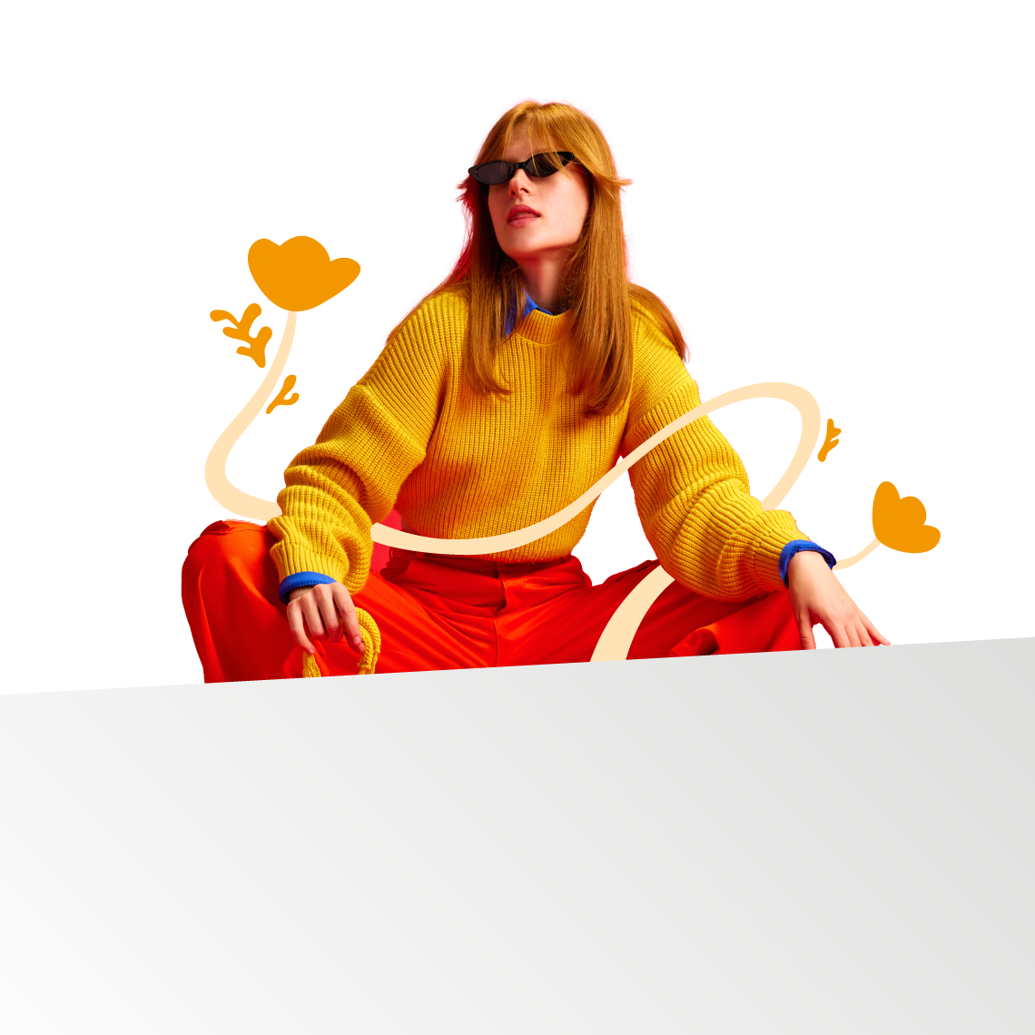 a women in orange sweatshirt with flowers around her