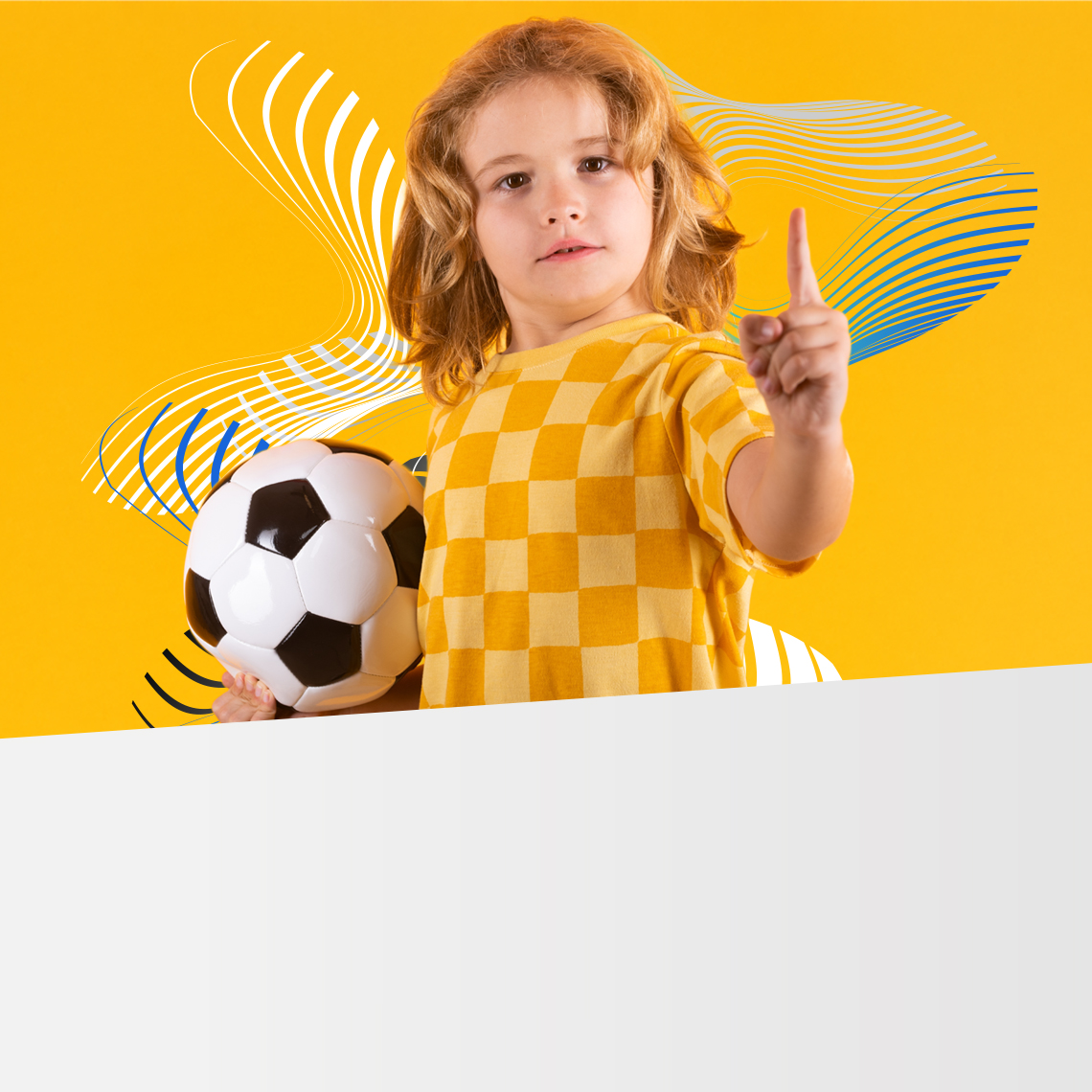 boy with a soccer ball under his arm