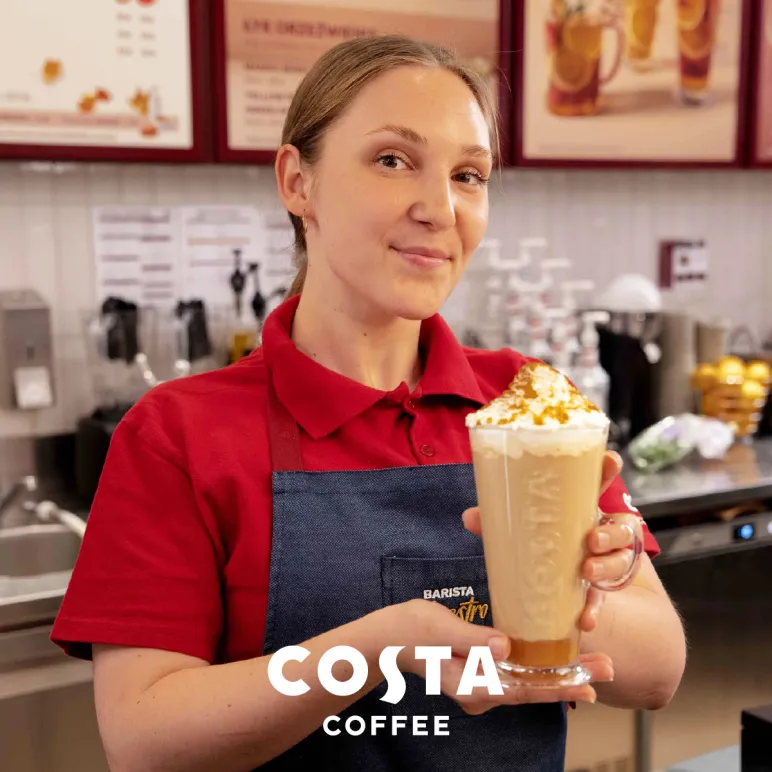 pracownica Costa Coffee z kawą w ręce
